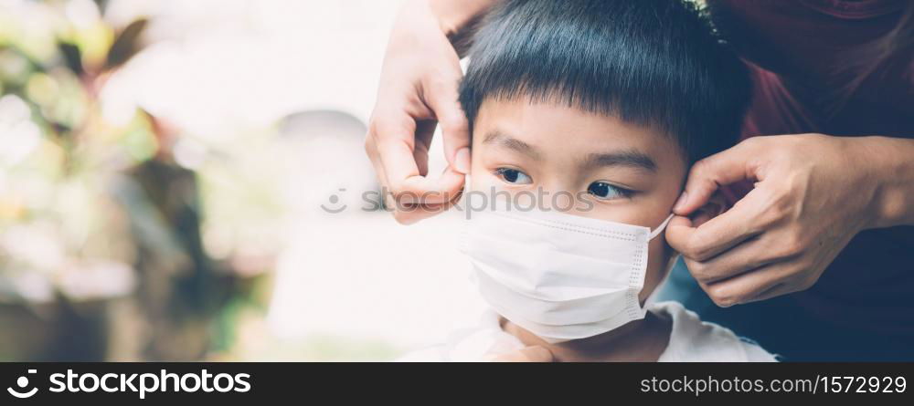 Mother take care son with face mask for protection disease flu or covid-19 outdoors, mom wearing on medical mask with child safety for protect outbreak of pandemic, medical concept, banner website.