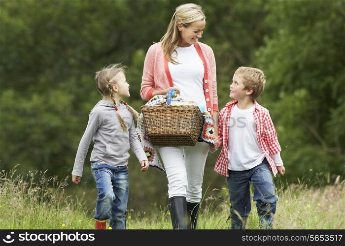 Mother Taking Children On Picnic In Countryside