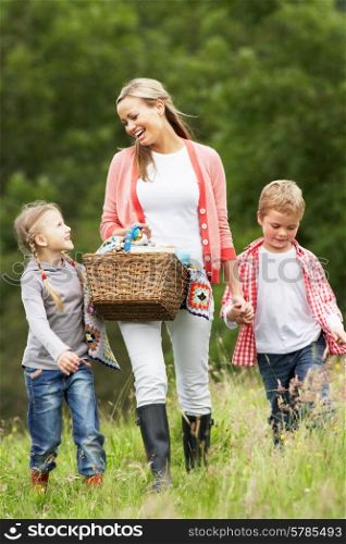 Mother Taking Children On Picnic In Countryside