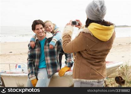 Mother Taking Family Photograph On Winter Beach