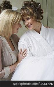 Mother talking to daughter in bathrobe