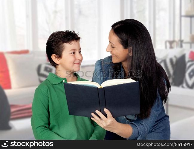 Mother teaching her child to read at home&#xA;