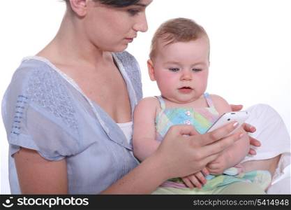 Mother teaching phone to baby