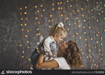 Mother throws daughter on the glittering lights.. Family games-tossing the baby up 7179.