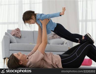 mother training with child indoors