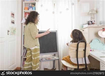 mother tutoring girl home