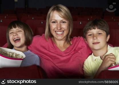 Mother Watching Film In Cinema With Two Children