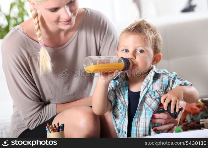 Mother watching son play with toys