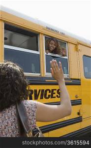 Mother Waving to Teenage Daughter on School Bus