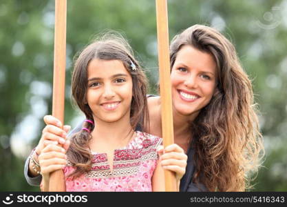 Mother with a daughter on stilts