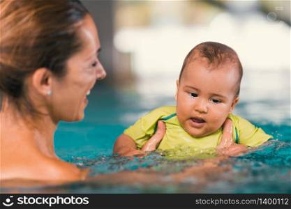 Mother with baby boy in the swimming pool