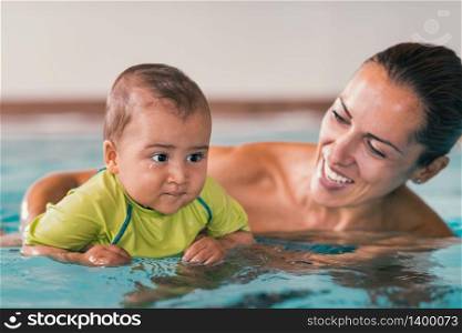 Mother with baby boy, swimming pool