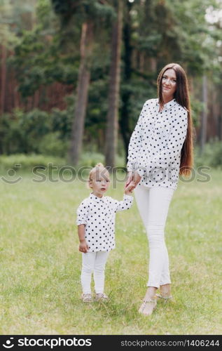 mother with baby girl outdoors. Happy family on summer walk Mother and daughter walking in the Park and enjoying the beautiful summer nature. selelective focus.. mother with baby girl outdoors. Happy family on summer walk Mother and daughter walking in the Park and enjoying the beautiful summer nature. selective focus