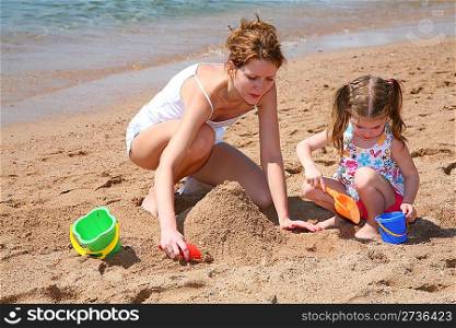 mother with baby on beach