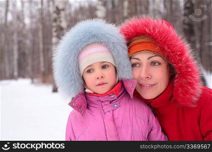 Mother with child in wood in winter