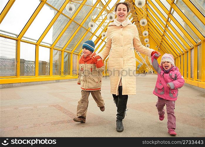 mother with children on footbridge