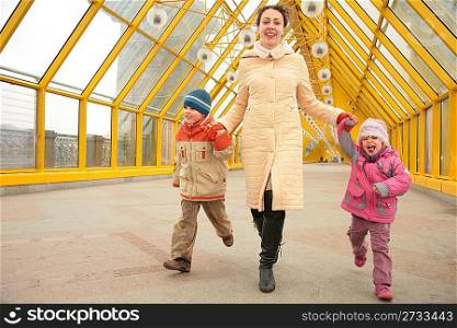 mother with children on footbridge