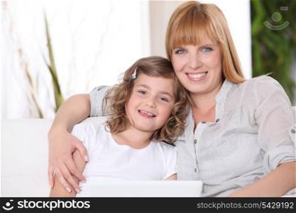 Mother with daughter and computer
