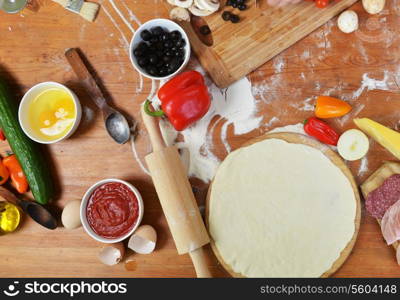 mother with daughter cut vegetables for pizzas