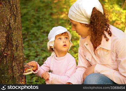 Mother with daughter in forest
