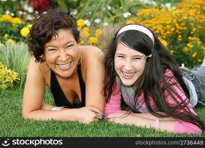 mother with daughter lies on grass