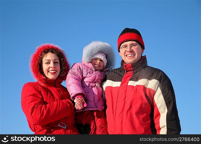 mother with father hold child on the hands in winter