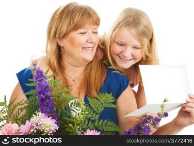 Mother with flowers and a card from her daughter. Birthday or Mother&rsquo;s Day concept.
