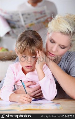 Mother with girl doing homework