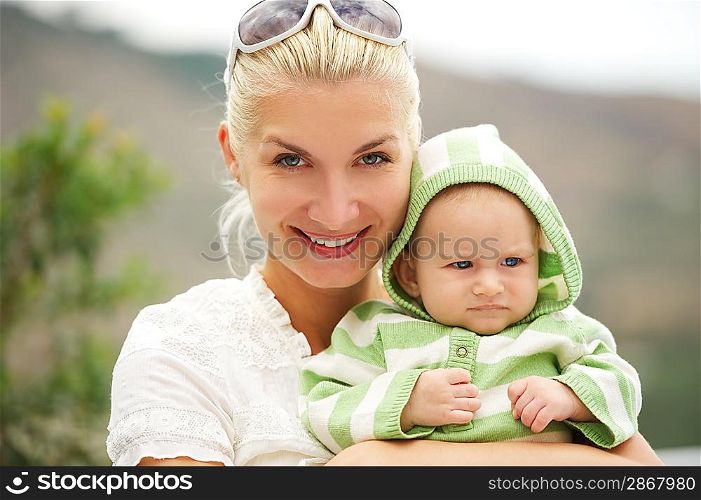 Mother with her adorable baby outdoors