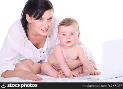 Mother with her baby and a laptop