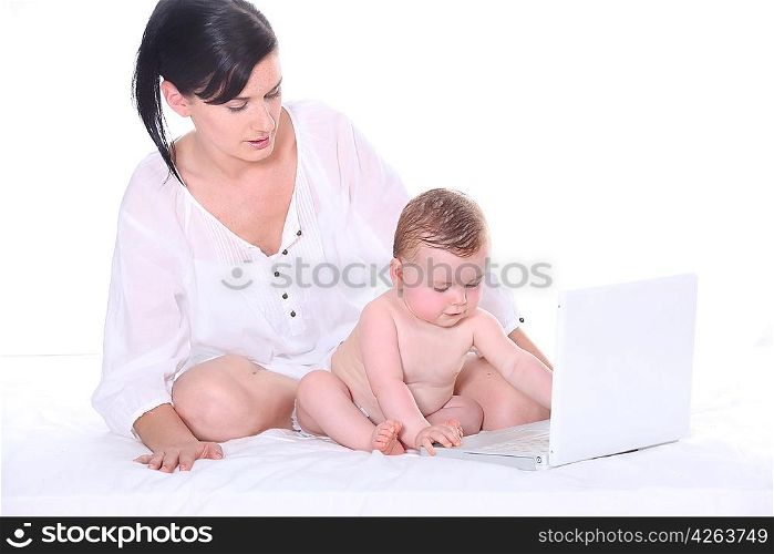 Mother with her baby in front of a laptop