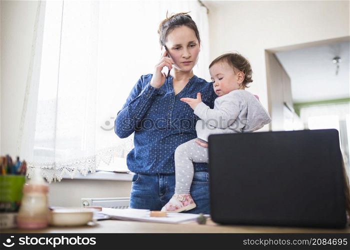 mother with her child talking smartphone