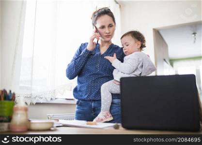 mother with her child talking smartphone