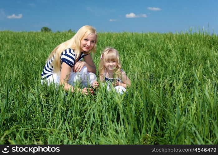 mother with her daughter outdoors in summer day