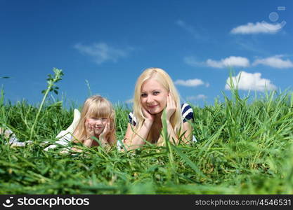 mother with her daughter outdoors in summer day