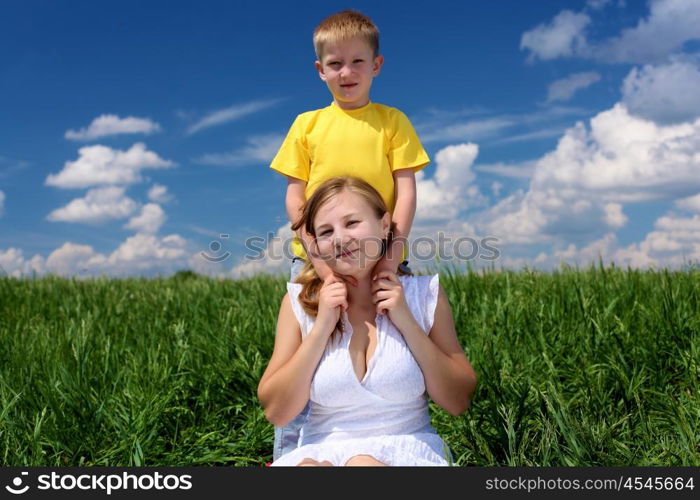 mother with her son outdoor in sunny summer day