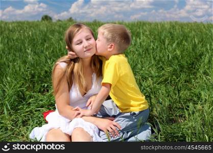 mother with her son outdoor in sunny summer day