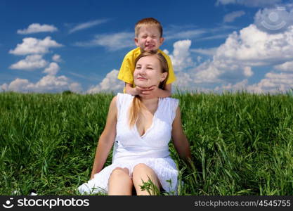 mother with her son outdoor in sunny summer day