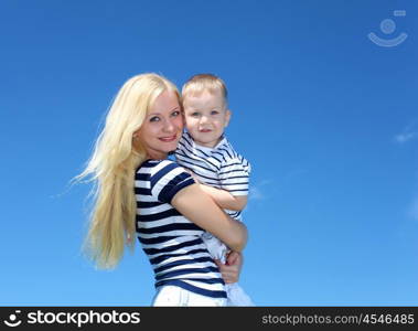 mother with her son outdoor in sunny summer day