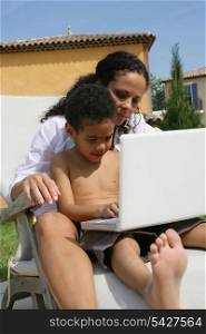 mother with kid using computer