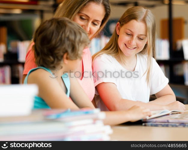 Mother with kids in library with books. Mother with kids in library