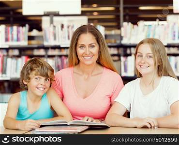 Mother with kids in library with books. Mother with kids in library