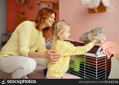 Mother with little daughter spending time at petting zoo or animal shelter. Cute child scratching cat neck. People emotion and pets concept. Mother with little daughter spending time at petting zoo or animal shelter
