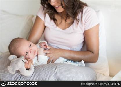 Mother with newborn baby in the nursing pillow