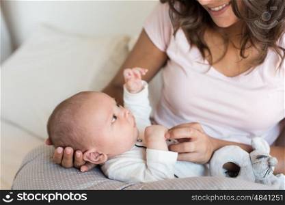 Mother with newborn baby in the nursing pillow