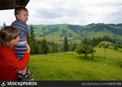 Mother with small boy look on mountain