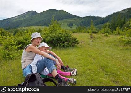 Mother with small girl on mountain background