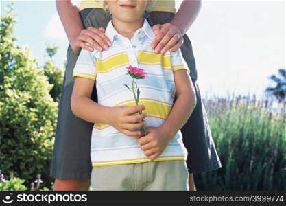 Mother with son holding flower