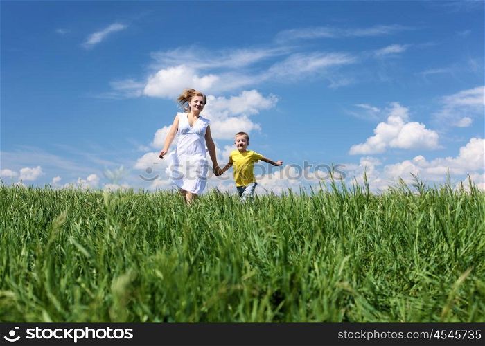 mother with son in summer day on the meadow