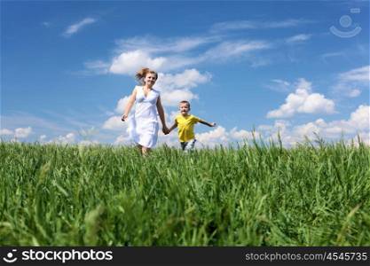 mother with son in summer day on the meadow